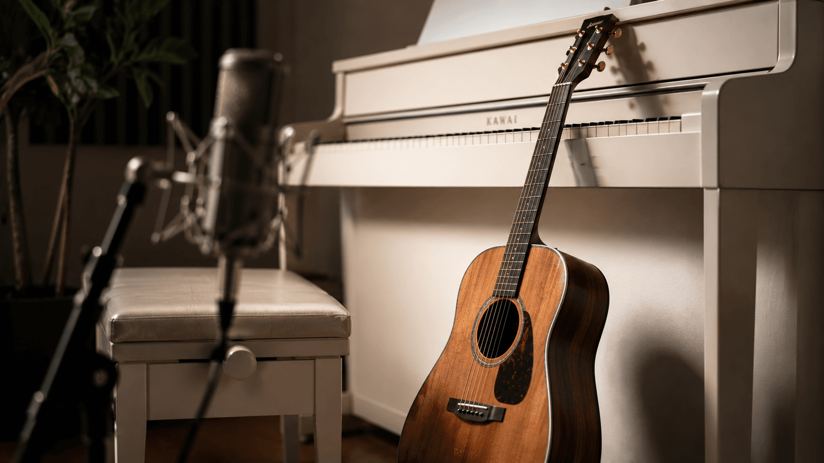 A piano, a guitar and a microphone in a quiet studio